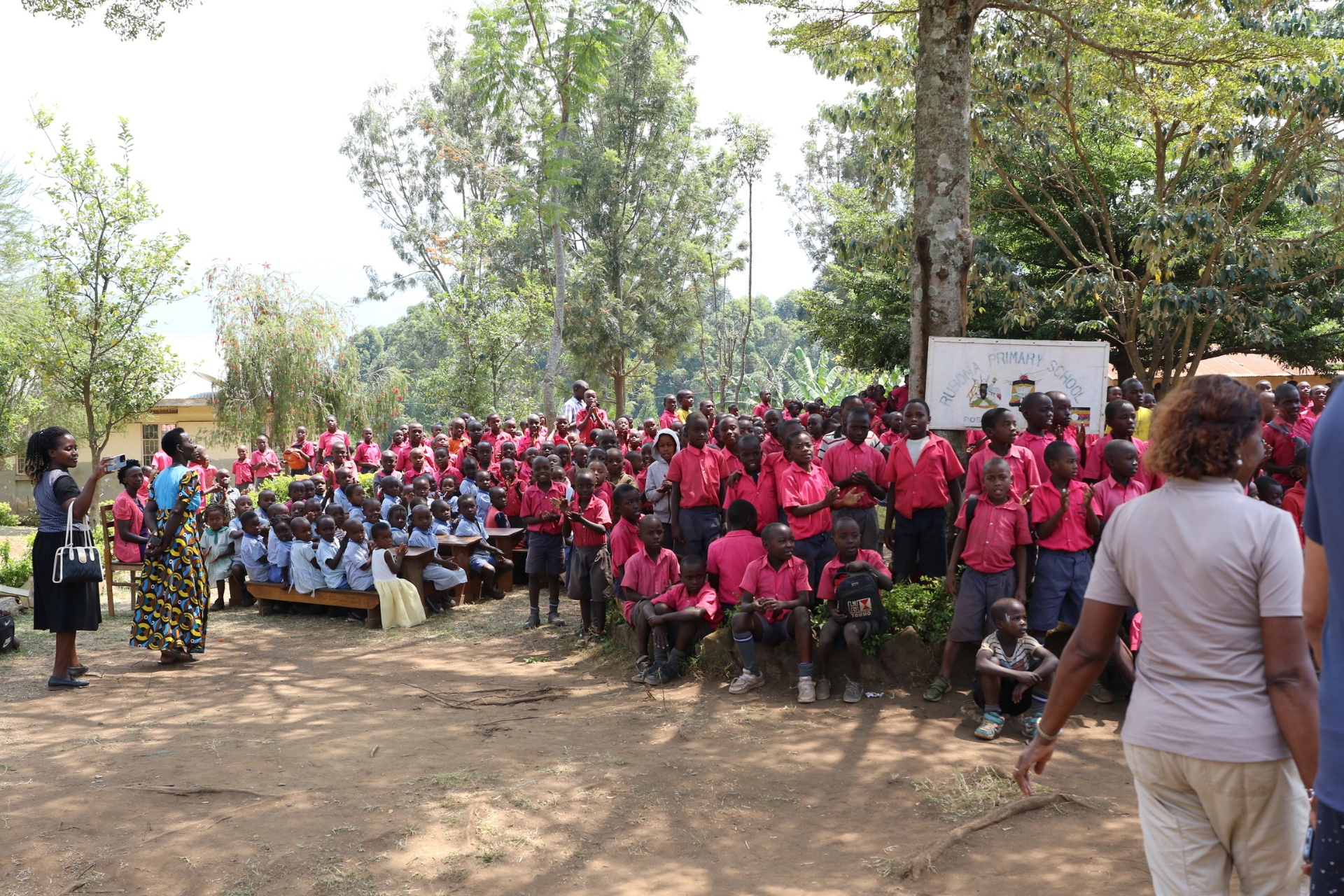 Students gathered outside Rubona Primary School in their pink and blue uniforms.